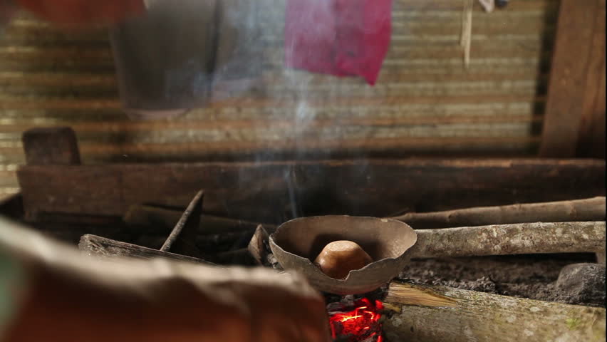 temperature is gently controlled by hand in order to prevent cracking while the craftman blows air with shes mouth
