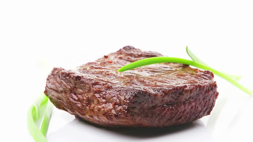 meat food : roasted fillet mignon on white plate with green sprouts isolated over white background
