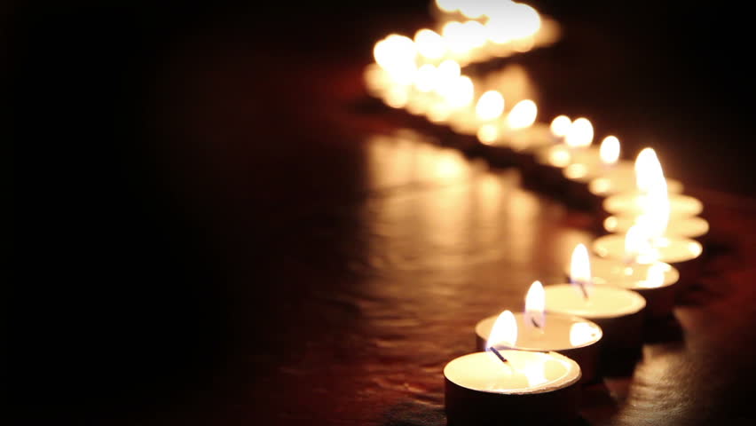 Candlelight. Little candles lined up light up one by one
