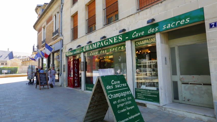 REIMS, FRANCE - JULY 24, 2012: Some tourists by a typical shops selling champagne, which cellars in Reims are very populars.
Every two seconds, a bottle of champagne is opened somewhere in the world!