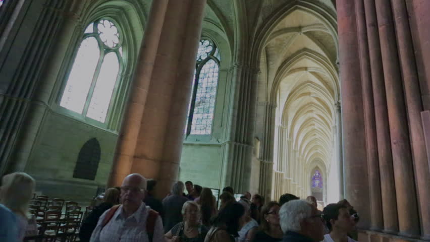 REIMS, FRANCE - JULY 24, 2012: Tourists and believers in the wonderful Roman Catholic church where the kings of France were once crowned