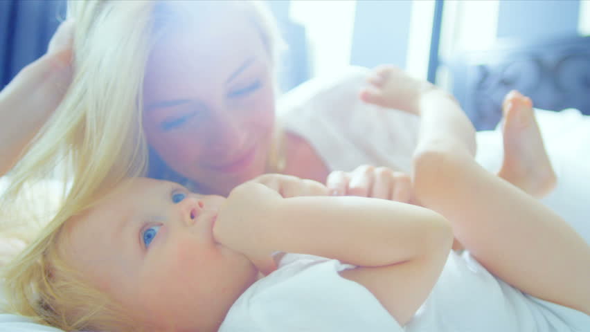 Little Blonde Haired Girl Laughing Mother