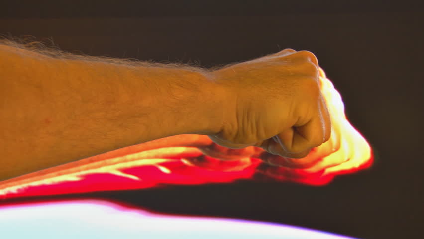 Slow punches against feedback background. Clip ends with rebellious clenched fist.