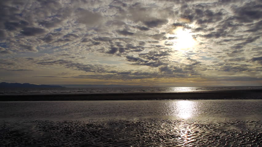 Late afternoon cloudy sunscape over Kachemak Bay looking west from the base of Homer Spit in mid-September.
