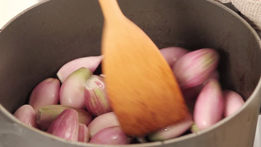 Shallots being fried (close-up)