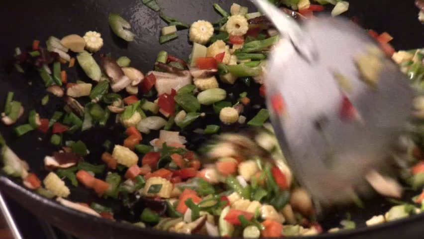 Stir-frying vegetables in a wok