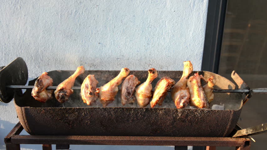 Chicken pieces cooking on a BBQ