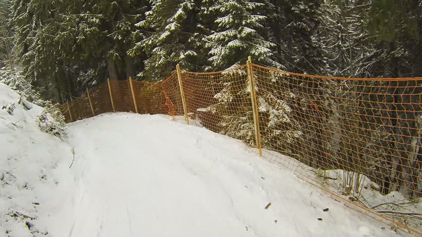 Slow motion: riding a snow track on snowboard