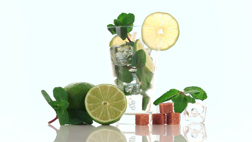 Pouring soda in mojito. Glass, lime, sugar, ice and mint