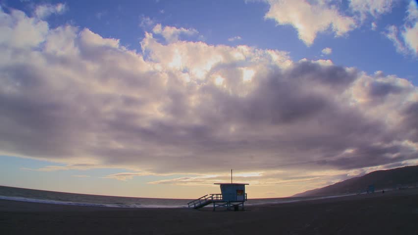 LOS ANGELES, CALIFORNIA, USA, 2012 Time lapse of a cloud formations moving behind a lifeguard station on a Los Angeles beach.