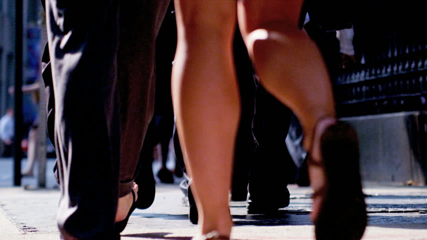 Lower body shot of city commuters on busy streets