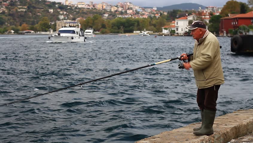 ISTANBUL - OCT 20: Senior fisherman passes hours along Bosporus Strait on October 20, 2012 in Istanbul. Fish stocks are declining very rapidly and the fishing sector is trying to catch what's left.
