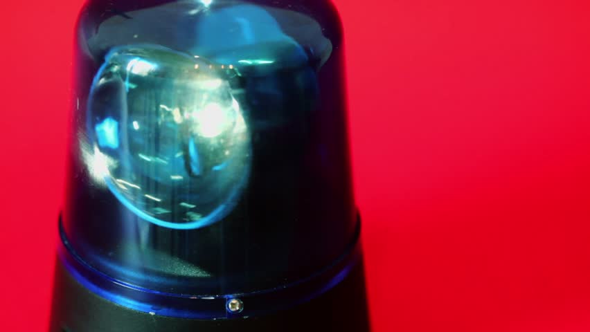 Bulb spins in blue flasher which moves slowly isolated on red