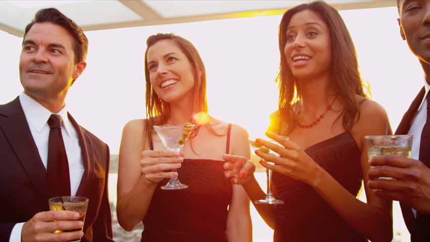 Diverse attractive couples dating at luxury rooftop cocktail party