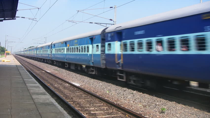 Indian passenger train passes by a countryside near Vijaywada, India.