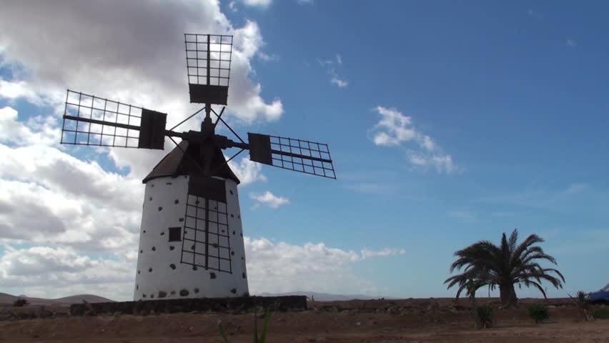 Old windmill in a spanish countryside with blue sky (Fuerteventura, Canary Island) - timelapse
