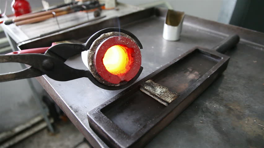 melting metal chips in the oven. gold ingot of smelted gold shavings. 3 shot sequwnce. 