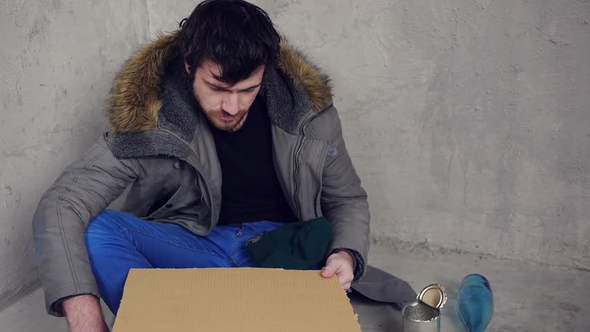 unemployment homeless designer sittin on the floor and asking for help