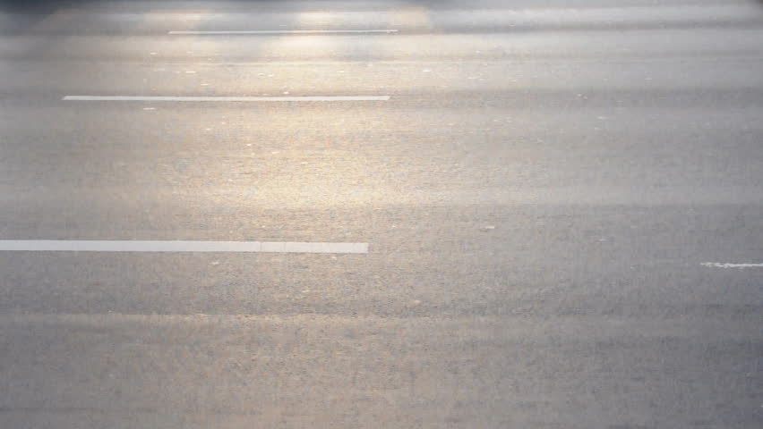Fast movement of vehicle on the asphalt street.