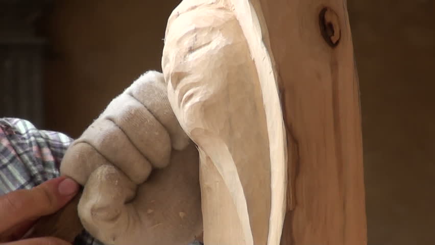 VERONA, ITALY - SEPT 1: Sculptor working on a wooden sculpture in a street demonstration on September 1, 2012 in Verona, Italy.