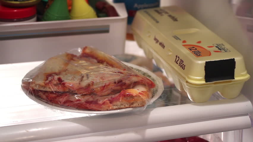 Getting a late night snack from the refrigerator.