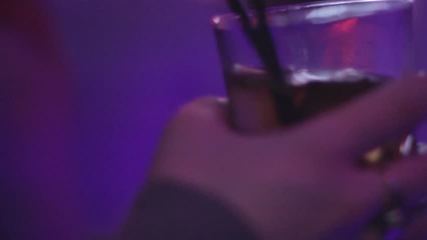 Hand holding cocktails during the party in night club

