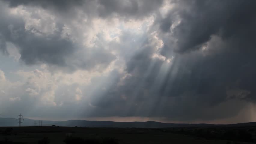 Sunbeams breaking trough the gaps of fast moving storm clouds over Thracian midlands, southeast Bulgaria.