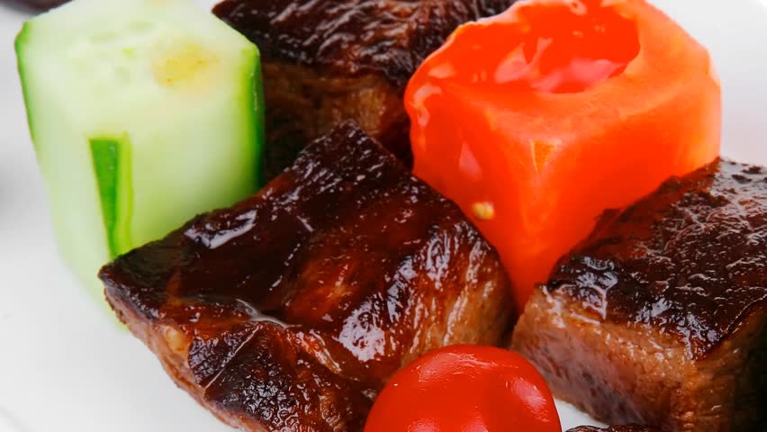 european food: roast beef meat goulash over white plate hidef slow motion intro with tomatoes and dill