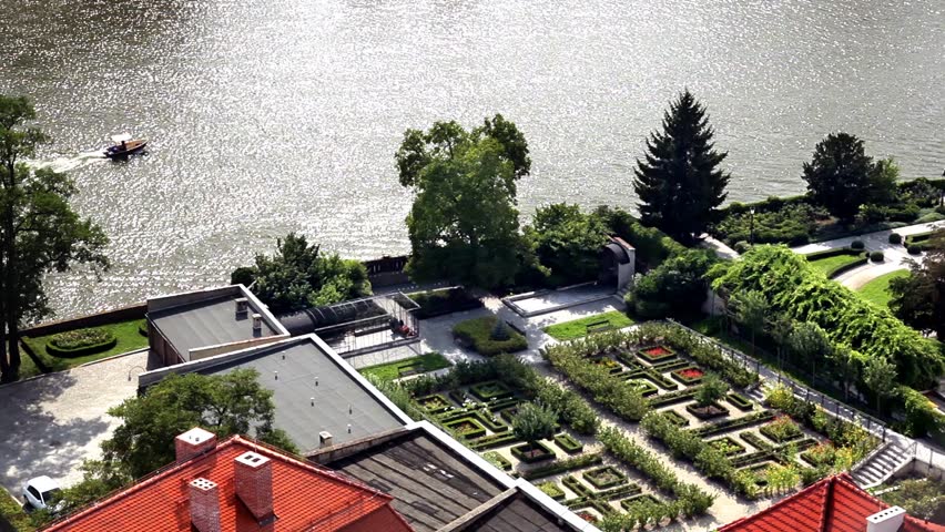 Motorboat flows through the river near beautiful garden. Time lapse.