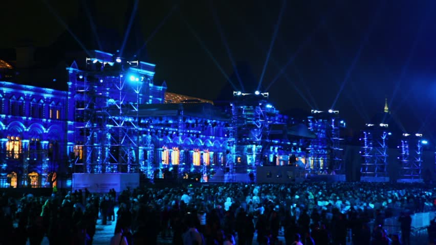 MOSCOW - OCT 21: Projectors rays in dark sky above crowd on Red Square near GUM in Moscow during Circle of Light festival, open event, Oct 21, 2011, Moscow, Russia.