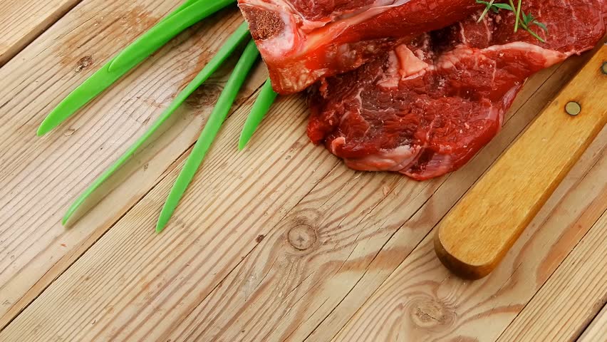 fresh raw meat : fresh red beef ribs with thyme red chili pepper and green onion on wooden board