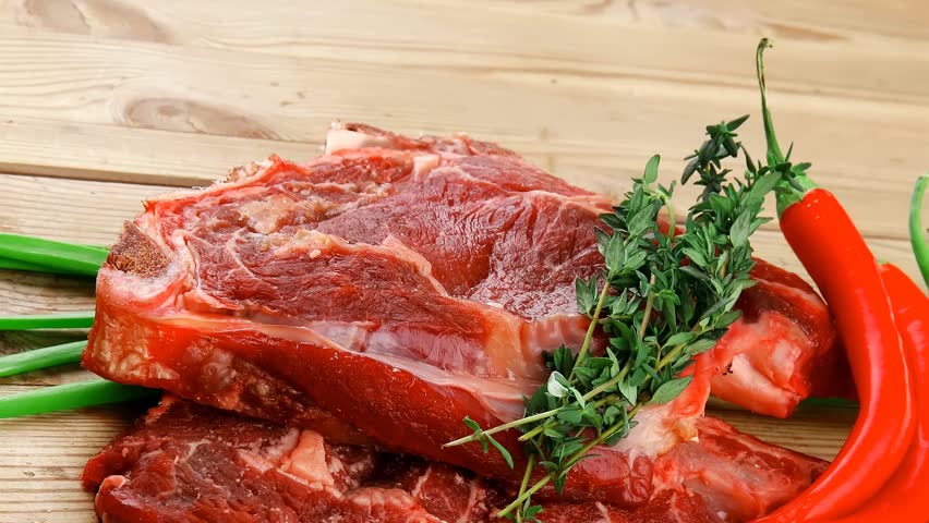fresh spare ribs : raw lamb with thyme red chili pepper and green onion on wooden board