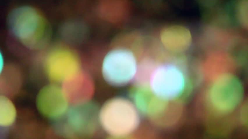 Beautiful colorful glitter floating in water creates a psychedelic bokeh.