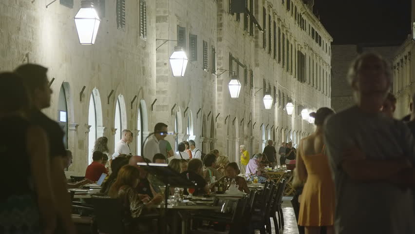 DUBROVNIK, CROATIA - SEPTEMBER 3 2012 - Summer atmosphere with tourists sightseeing and movement around cafe bars in the old town main street Placa on September 3, 2012. in Dubrovnik, Croatia.