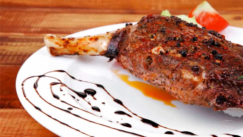 meat savory: roast shoulder on black plate hidef slow motion intro