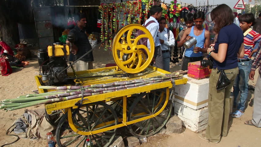 PUSHKAR, INDIA - NOVEMBER 22, 2012: Machine press fresh juice from sugar-cane at fair in Pushkar, India, 22 nov 2012