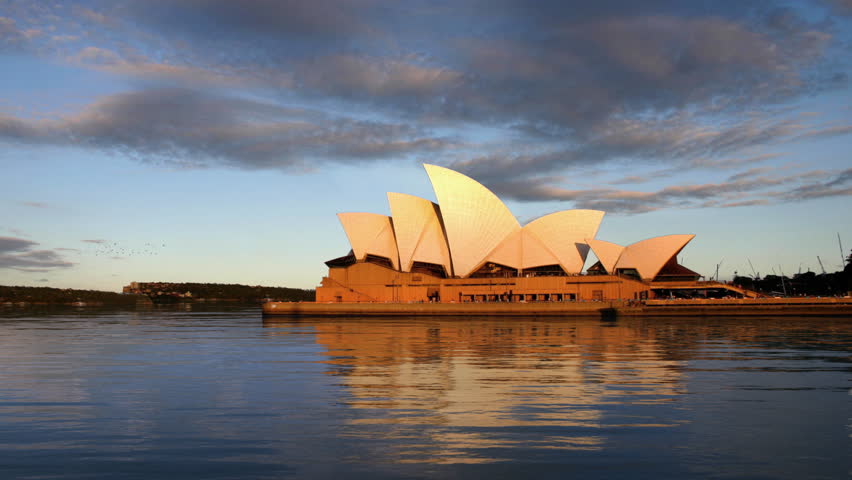 Sydney Opera House, a World Heritage site and a masterpiece of 20th-century architecture at sunset with calm water, HD1080p