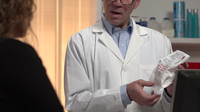 Pharmacist thoroughly explaining to patient about the prescription drug.