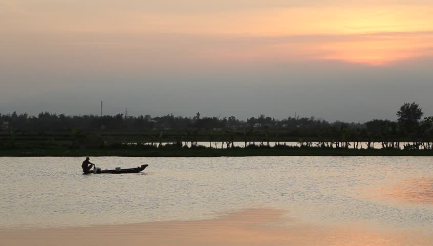 Fisher man on boat in the river 