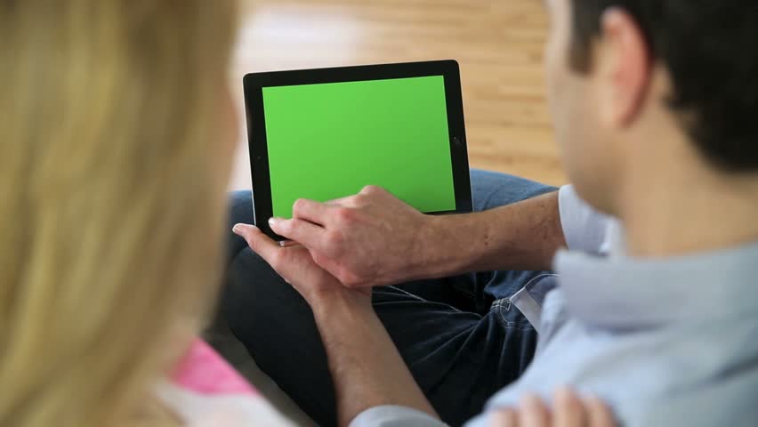 Couple looking at pictures on electronic tablet