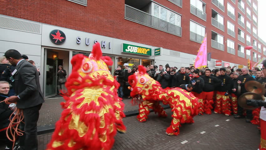 THE HAGUE, HOLLAND - JANUARY 9: Dragons visit a cafe on Chinese New Year in Chinatown in The Hague, Holland on January 9, 2013. Dragons customarily visit shops to receive gifts.