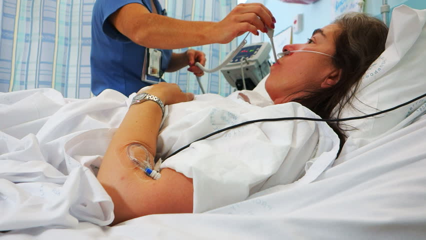 a nurse measures the temperature of a female patient