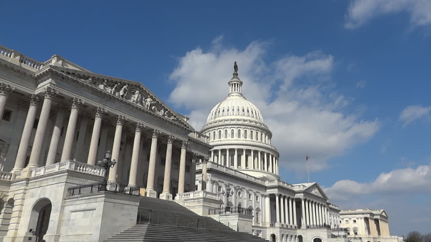 Panning shot of US Capitol view from 1-st Street on cloudy sky background
