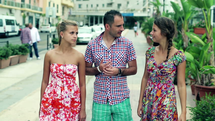 Group of friends after shopping walking on the street, steadycam shot
