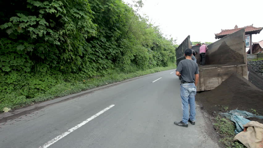 BALI - JANUARY 25: Lorry traffic on road on January 25, 2012 in Bali, Indonesia. With Bali rise in population from 800.000 to 3.5 million, road development has had to follow.