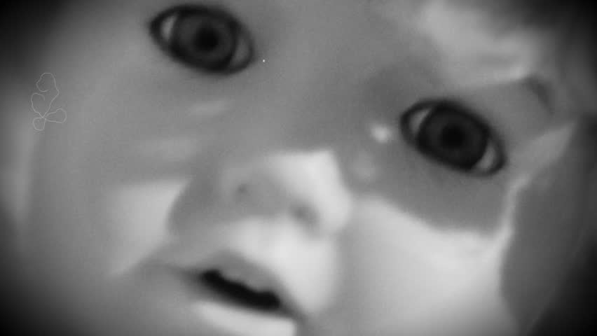 A creepy doll doing something weird with its eyeballs.