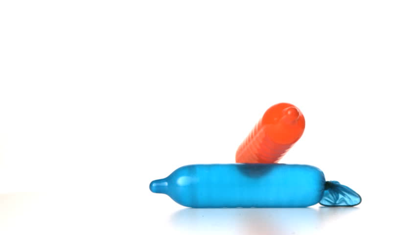 Blown up condom falling on another on white background in slow motion