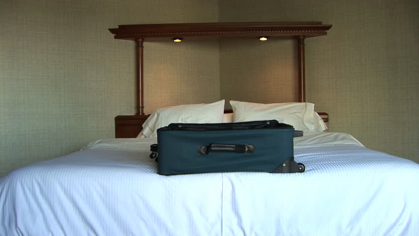 Luggage sitting on big bed, Seattle, Washington, zoom in