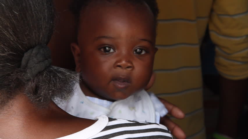 HAITI - CIRCA MAY 2012: young Haitian baby, closeup waiting in line for vaccination with mother in Port -Au-Prince, Haiti. 