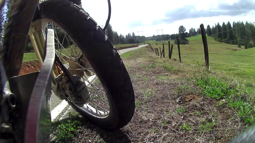 TIME LAPSE MOTORCYCLE DUAL SPORT MOTORBIKE WITH  UNIQUE POV POINT OF VIEW  CAMERA PERSPECTIVE ON FRONT WHEEL THROUGH COUNTRY ROAD.